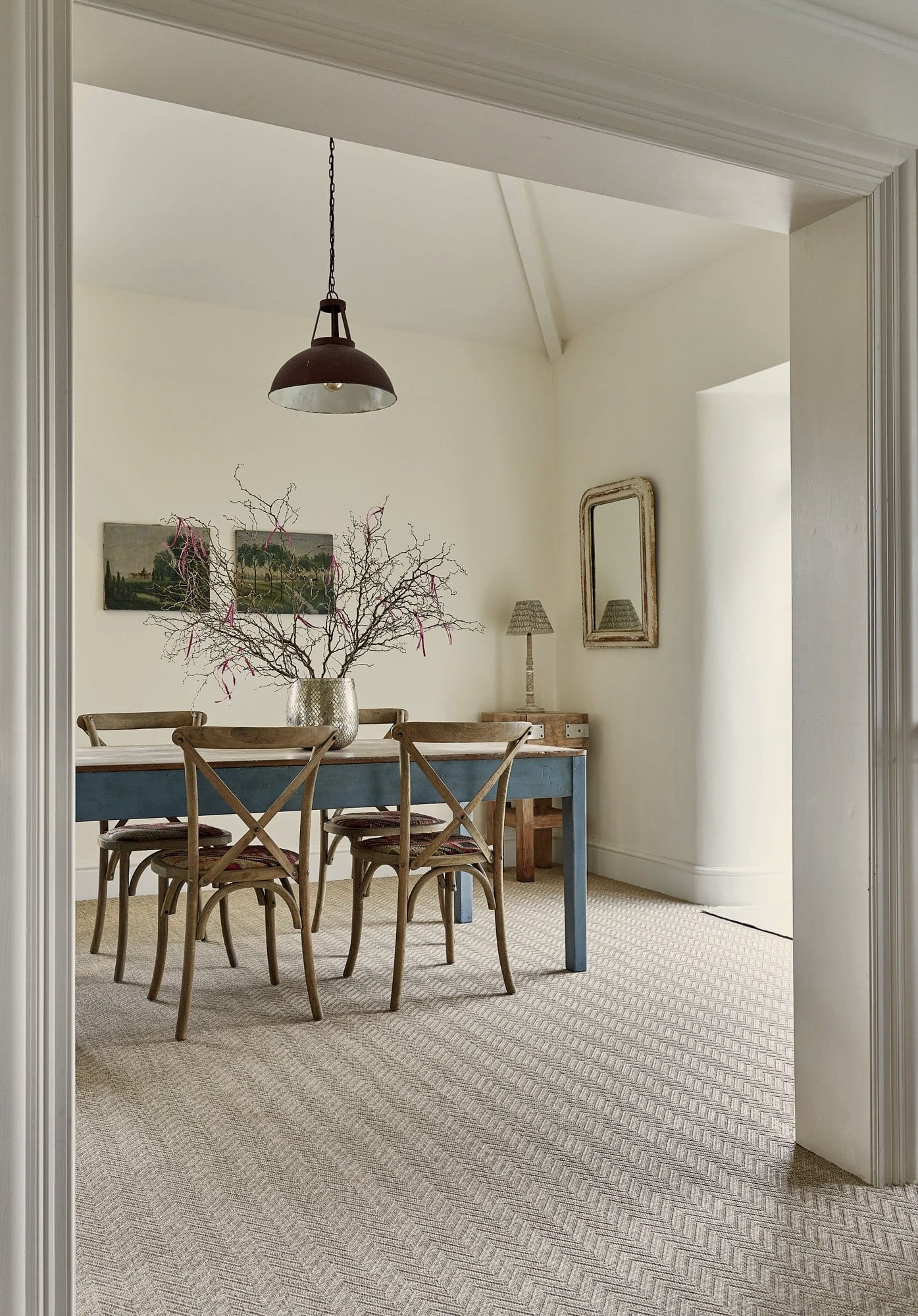 Herringbone woven flooring in a bright dining room