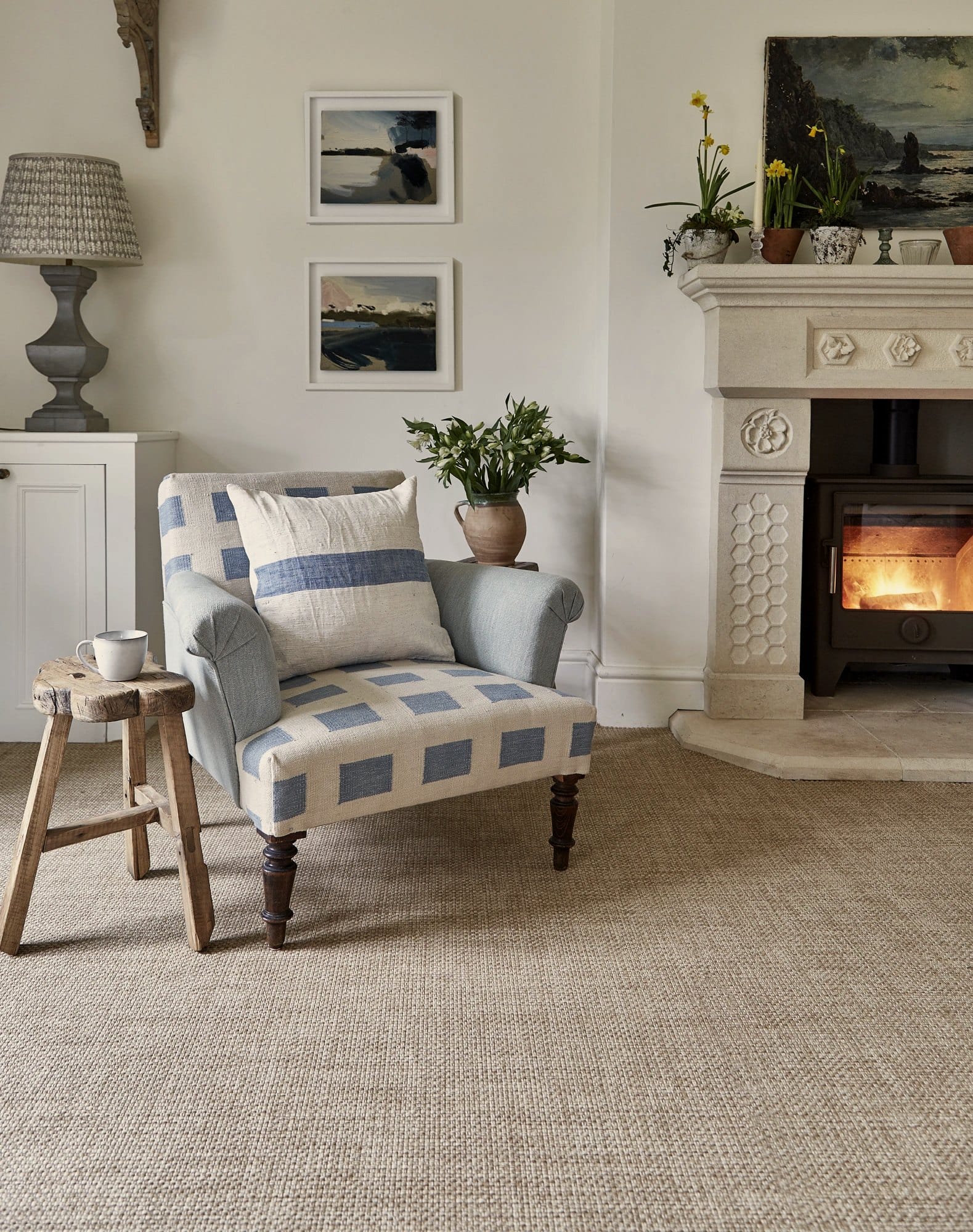 Woven flatweave flooring beside a lit fireplace